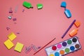 Stationery items on the pink background with free space for text. Creative, colorful background with scool supplies Royalty Free Stock Photo