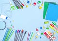 Stationery, notepads, paints, felt-tip pens, markers with place for text on a blue background Royalty Free Stock Photo