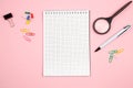 Stationery, paper notebook with pen and magnifier on pink isolated background. top view. flat lay. mockup