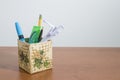 Stationery products and an origami parrot in a box Royalty Free Stock Photo