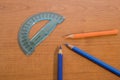 Stationery products, a protractor and some colored pencils on a