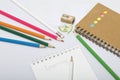 Stationery for school and teaching. Notepad and pencils for writing and drawing. Pencil sharpener with pencil shaving. Royalty Free Stock Photo