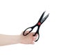 Stationery scissors in the hand of caucasian woman. White isolate Royalty Free Stock Photo
