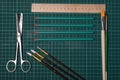 Stationery set. Office, school supplies. Scissors, brushes, pencils on a cutting mat Royalty Free Stock Photo