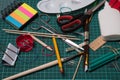 Office, school supplies. Scissors, brushes, paper clips, pencils on a cutting mat Royalty Free Stock Photo