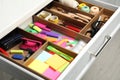 Stationery and sewing accessories in open desk drawer