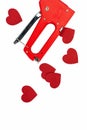 Stationery stapler and paper hearts on a white isolated background Royalty Free Stock Photo