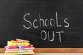 Stationery near blackboard with text School`s Out. Summer holidays Royalty Free Stock Photo