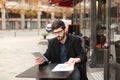 Statistician working with diagram and tablet at cafe table . Royalty Free Stock Photo