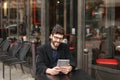 Statistician working with diagram and tablet at cafe table . Royalty Free Stock Photo