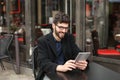 Statistician working with diagram and tablet at cafe table . Royalty Free Stock Photo