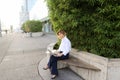 Statistician working outside with laptop and color diagrams. Royalty Free Stock Photo