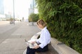 Statistician working outside with laptop and color diagrams. Royalty Free Stock Photo