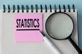 STATISTICS - word in notepad with magnifying glass and pen