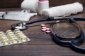 Statoscope and pills over brown wooden table Royalty Free Stock Photo