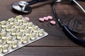 Statoscope and pills over wooden table Royalty Free Stock Photo