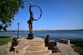 Statue along the lake in loveland colorado with the rocky mountains in the background