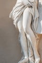 Statue of ancient sensual half naked Renaissance Era woman with long baked legs in Potsdam at smooth wall background, Germany Royalty Free Stock Photo