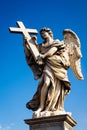 Statue of an angel carrying a cross on the Sant Angelo bridge in Rome Royalty Free Stock Photo