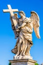 Statue of an Angel with the Cross on Sant`Angelo Bridge in Rome, Italy Royalty Free Stock Photo