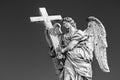 Statue of an Angel with the Cross on Sant`Angelo Bridge in Rome, Italy Royalty Free Stock Photo