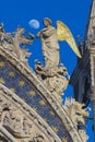 Statue of angel with golden wings decorating upper facade of the Saint Mark`s Basilica in Venice, Italy.