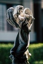 Statue of an angel playing violin in the garden