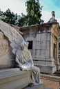 Statue of angel reading next to a pantheon Royalty Free Stock Photo