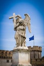 Statue of Angel at Sant Angelo Bridge in Rome Italy with european union Flag in the Background Royalty Free Stock Photo
