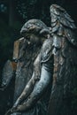 A statue of an angel sitting on a grave, with a serene expression Royalty Free Stock Photo