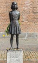 Statue of Anne Frank holding flowers in Utrecht