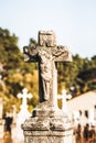 Statue of antique cross with the crucified Christ on the old 19th century cemetery. Ukraine Royalty Free Stock Photo