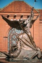 Statue Of Archangel Michael near Red Catholic Church Of St. Simon And St. Helena Royalty Free Stock Photo