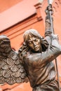 Statue Of Archangel Michael With Outstretched Wings Before Red C Royalty Free Stock Photo