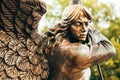 Statue Of Archangel Michael With Outstretched Wings Before Red Catholic Church Of St. Simon And St. Helena