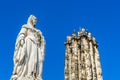 Statue of Archduchess Margaret of Austria and the tower of Saint Rumbold`s Cathedral in Mechelen, Belgium