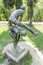 statue by author S.Koci of a man jumping over another, central park in the center of the capital Tirana in Albania.