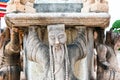 The statue of a beard holding a stone base at Wat Pho, Pho temple,   `Temple of the Reclining Buddha` Bangkok Thailand. Royalty Free Stock Photo