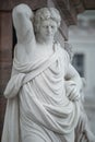 Statue of beautiful Roman noble man at the obelisk in the Old Market square Alter Markt in downtown of Potsdam, Germany