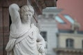 Statue of beautiful Roman noble man at the obelisk in the Old Market square Alter Markt in downtown of Potsdam, Germany