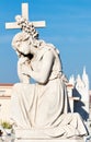 Statue of a beautiful young woman holding a cross Royalty Free Stock Photo