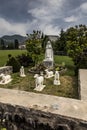 Statue of Bernadette of Lourdes with sheep in Lourdes