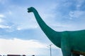 Statue big dinosaur in the park with blue sky at khon kaen, Thailand.