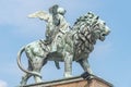 Statue of a big lion with genius of music, an angel with wings and a musical instrument at Concert Hall Konzerthaus, in Berlin,