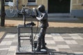 Statue of a blacksmith in cast iron, holding two keys, the coat of arms of the municipality of Waddinxveen in the Netherlands