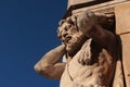 Statue of blacksmith Juraj Corgon, as Atlant supporting corner of bishop palace in Nitra, Slovakia.