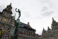 Statue of Brabo and the giant`s hand with the Antwerp City Hall in Antwerp Royalty Free Stock Photo