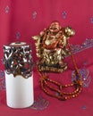 Statue of Buddha, candle, beads made of wood Royalty Free Stock Photo