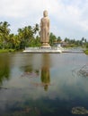 Statue of Buddha by lake