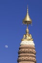 Statue of Buddha with many tiered umbrella.